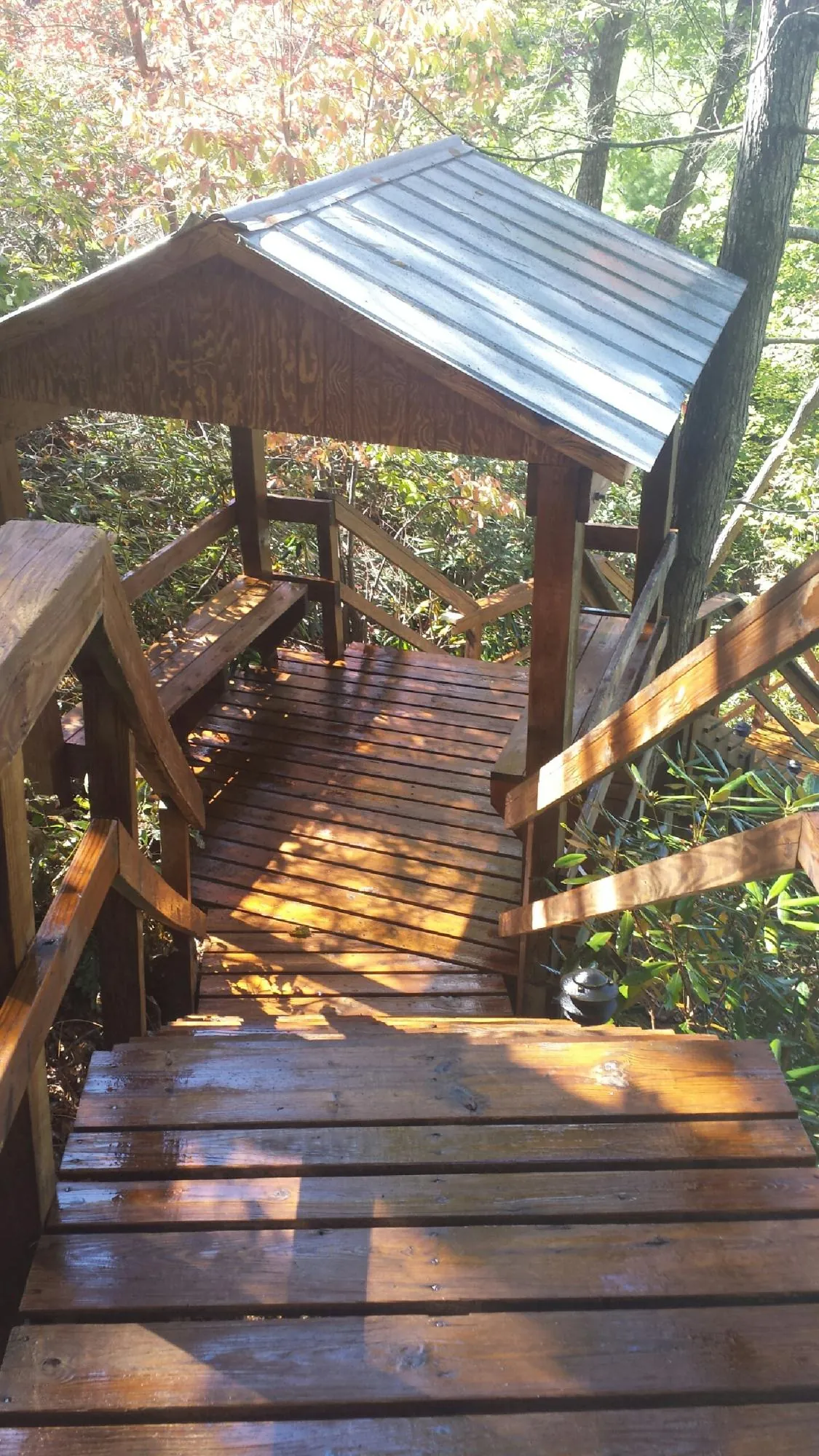Freshly stained wood walkway and covered shelter with a metal roof in Buckeye Lake