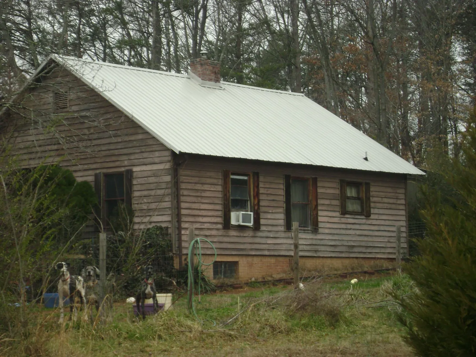 White metal roof on an old wood sided farmhouse, from a Asphalt Shingle Roof Repair job in Buckeye Lake